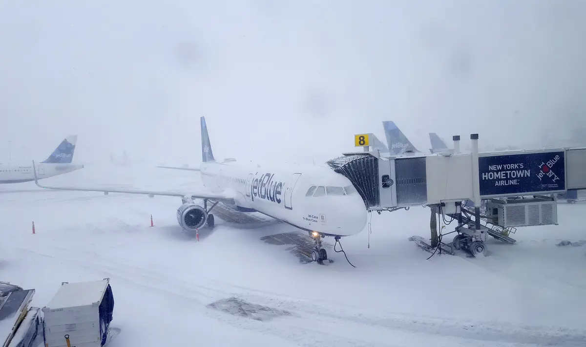 airport during a snow blizzard with thick snowfall and near-zero visibility.