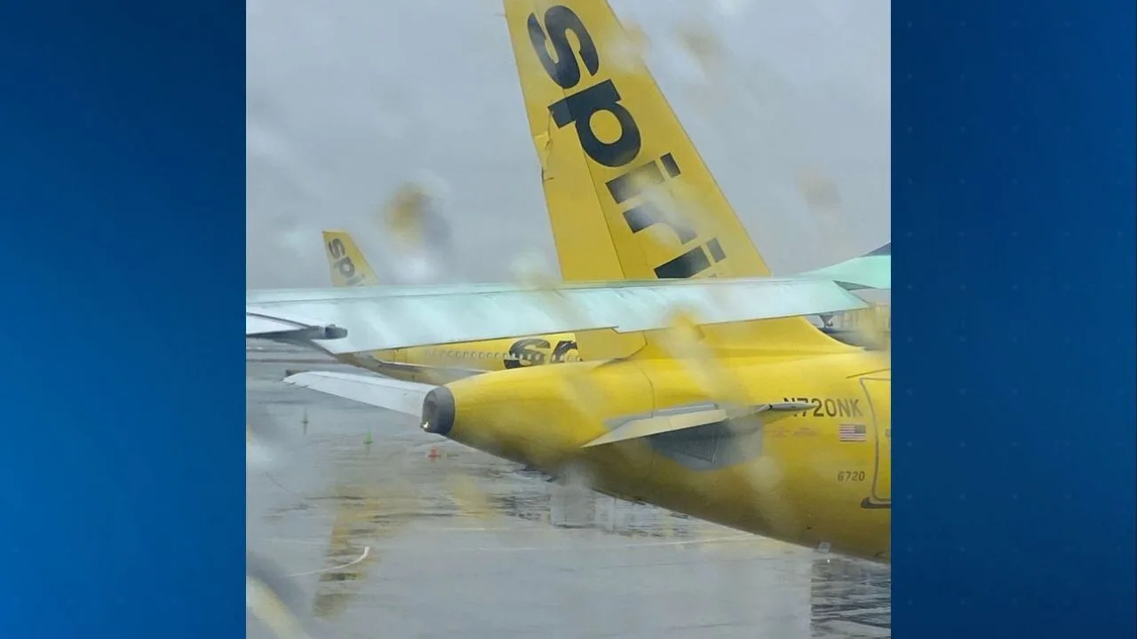 Spirit Airlines Airbus A321 vertical stabilizer damaged after ground collision with Singapore Airlines A350 during pushback at Newark Liberty International Airport.