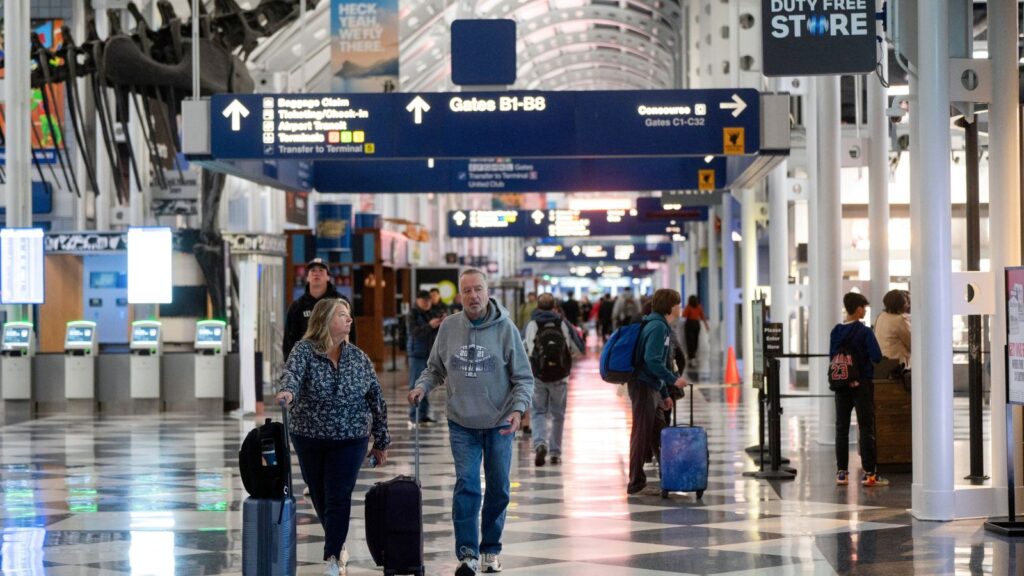 Passengers waiting inside a busy airport terminal as widespread flight delays impact major U.S. airports.